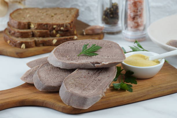 sliced boiled beef tongue slices on wooden board with mustard - smoked tongue imagens e fotografias de stock