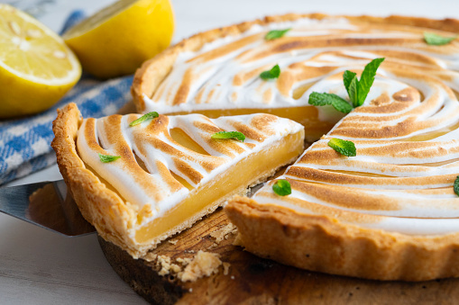 A piece of delicious lemon cake on a rustic wooden table