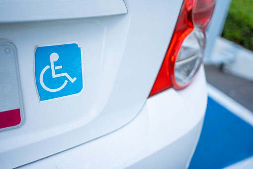 car with a disabled sticker on, automobile with disability license plate wheelchair sign