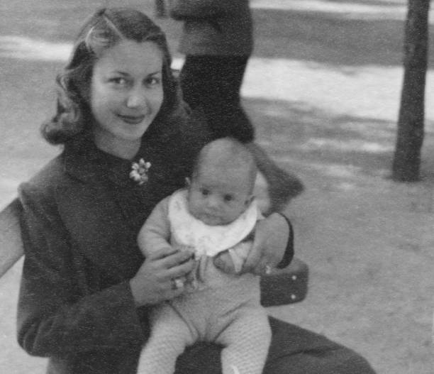 Mather and son in 1934. Mather and son on a bench in a public park. 1934. 1934 stock pictures, royalty-free photos & images