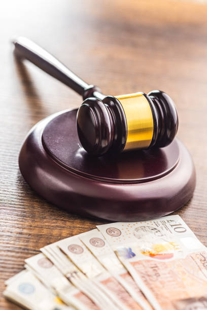 istock Judge gavel and british pound sterling on wooden table. 1707437101
