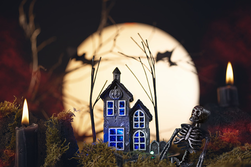 Halloween night with haunted house and full moon. Halloween holiday background.