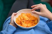 Chips in a porcelain bowl at a party, unhealthy snacks