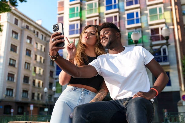 Smiling Multicultural Models Capture Urban Selfie Amidst Vibrant Cityscape