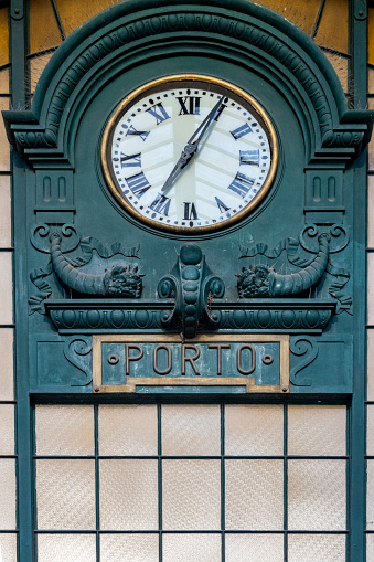 Porto, Portugal The clock hanging in the interior of the Sao Bento Train station.