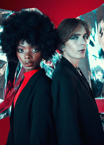 istock Retro, portrait and people on a studio background for art, rock or creative aesthetic. Makeup, fashion and a black woman with a man for a punk or vintage couple isolated on a studio backdrop together 1707507290