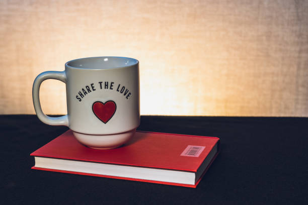istock Mug with a book the theme of learning or creating a postcard 1707539516