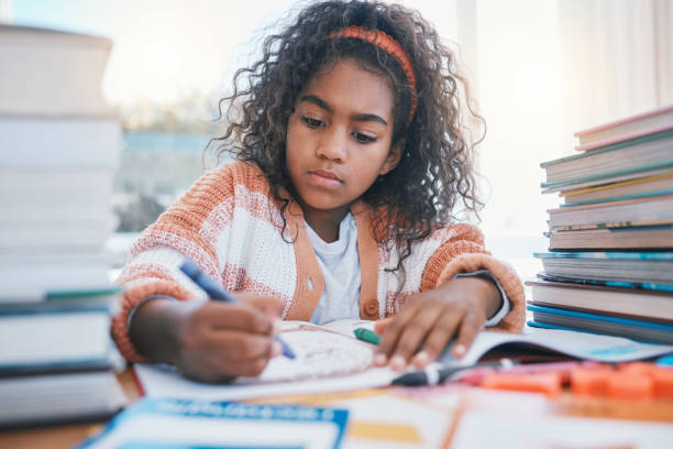 istock Education, art and kid coloring in a book for artistic project, assignment or fun. Colors, crayon and girl child student writing for creative learning in a notebook for homework by a desk at home. 1707550970