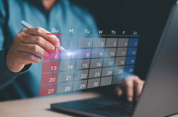 istock Businessman use computer and touch virtual calendar screen. Make appointment reminders or meeting agenda on the calendar. Time management concept. Secretary manages schedule for time-effective work. 1707554399