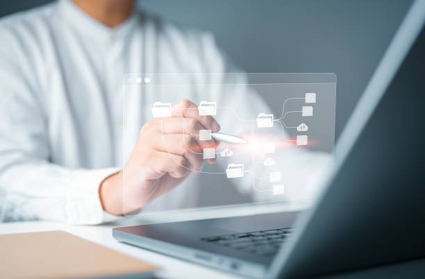istock Man use computer laptop to manage files on server. Cloud backup merges online documentation or digital file storage software, file sharing application, database download, upload and permission access. 1707566890