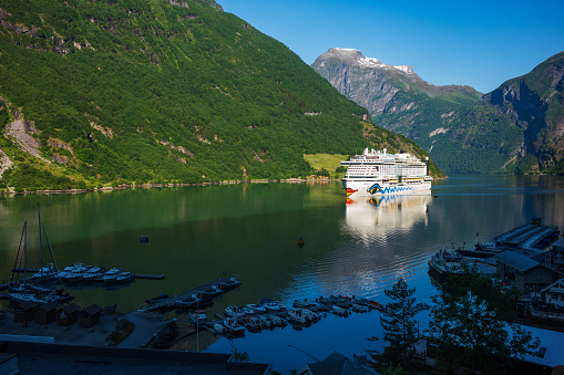 Geiranger, Norway, Jun 26, 2023: AIDAperla, a cruise ship of AIDA Cruises that can host over 3200 passengers, comes into port in the morning. Norway is one of the busiest cruise countries worldwide.