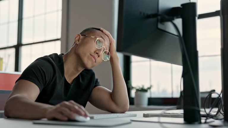 Bored office worker using computer