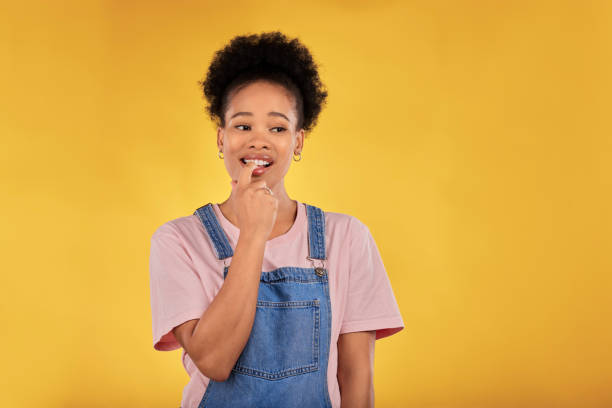 istock Woman, student and thinking or doubt for university, college or education choice and decision. Ideas, nervous and african person for college mistake, study results or plan on yellow studio background 1707597085