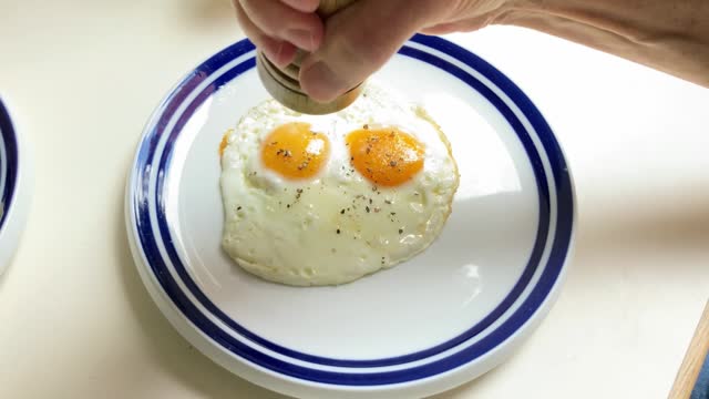 Mature man hands and fried eggs for breakfast