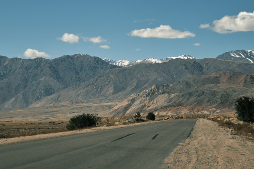 Empty asphalt road through mountain ridge