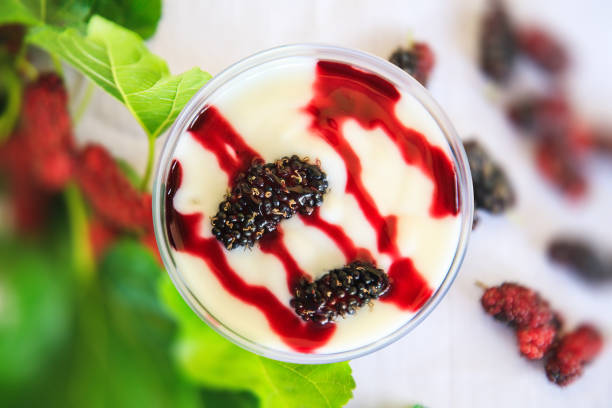 Fresh greek yogurt with mulberry  in cups,  with mulberries on view from above