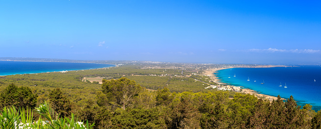 A panoramic views of viewpoint of la Mola in the balearic island of Formentera with the two bays of water. One bay of Calo the Sant Agusti, and the other bay of Migjorn beach.