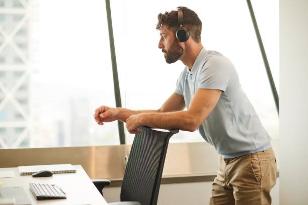 istock Business Communication: Office Worker with Headset on Phone 1707657588