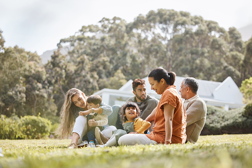 istock Happy, big family and garden of new home with love, support and grandparents with parents and kids. Backyard, smile and moving of mother, father and children together with bonding outdoor and field 1707657959