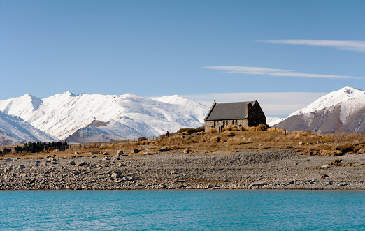 Winter sunlight falls upon the famous Church Of The Good Shepherd on the shores of Lake Tekapo.