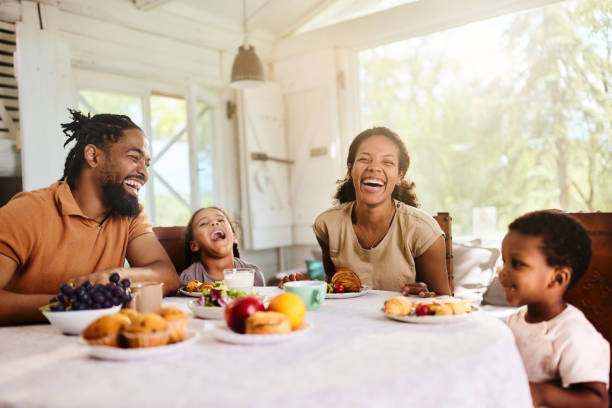 istock Cheerful black family having breakfast at dining table. 1707679131