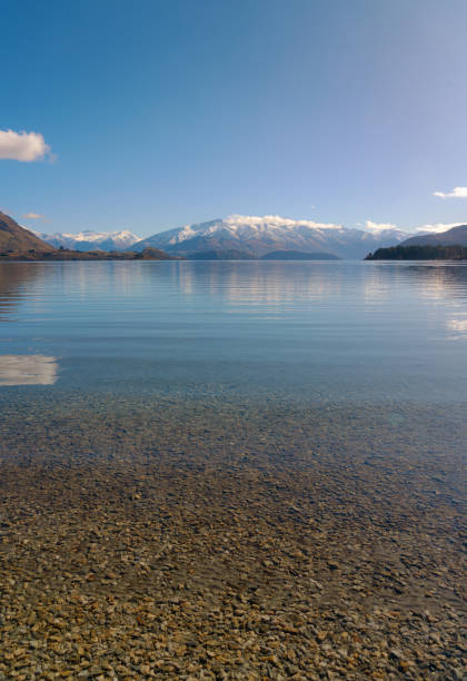 A portrait of New Zealand's beautiful Lake Wanaka, with the snow covered Southern Alps in the distance.