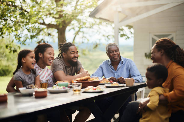 istock Happy black extended family talking while having a meal at patio. 1707680199
