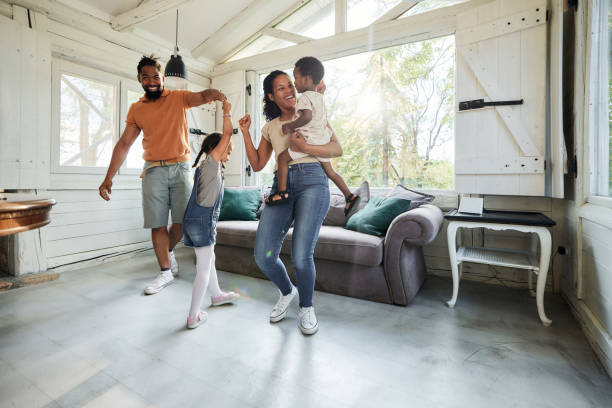 istock Happy black family having fun while dancing at home. 1707682912