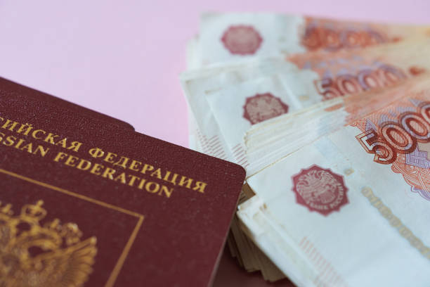 istock Russian passport and banknotes  on pink background. 1707694827