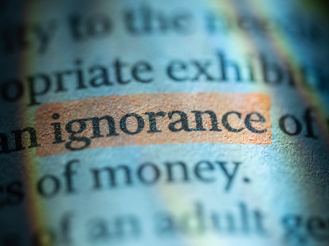 Ignorance word, written in a financial newspaper. Colors produced by color filters in flashes
