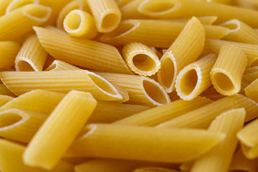 Macaroni, pasta, made by durum wheat.Pasta background. Testure for design.