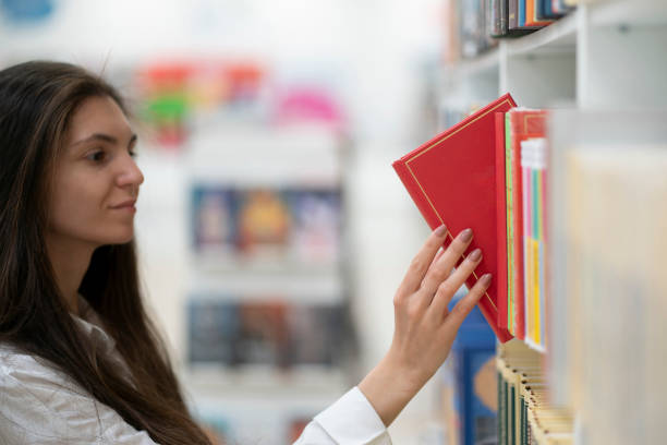 istock choosing and picking the right book in the store on the shelf 1707736532