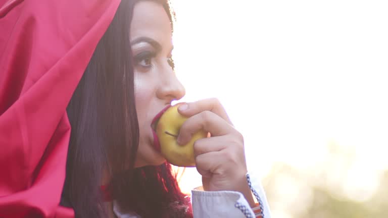 Little Red Riding Hood Eating An Apple In The Forest