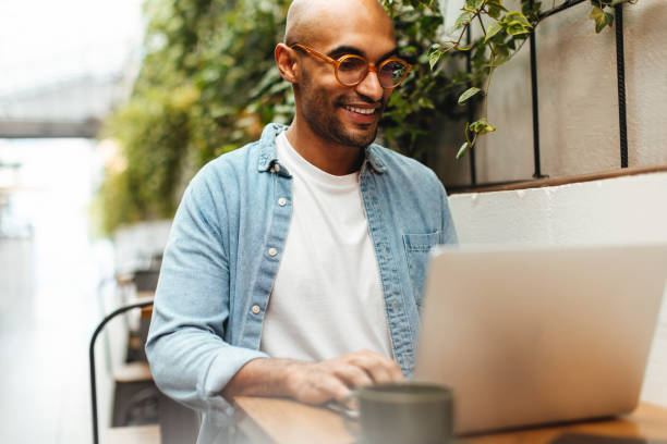 istock Working from anywhere: Freelancing man using his laptop in a coworking space 1707750050