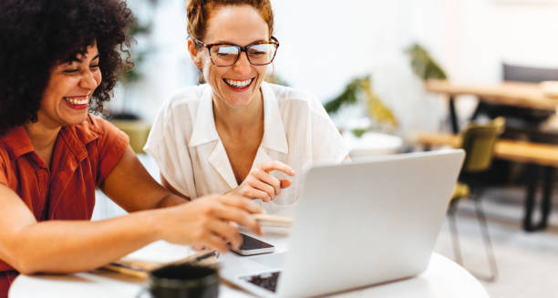 istock Two happy women using a laptop to brainstorm in a coworking space 1707750159