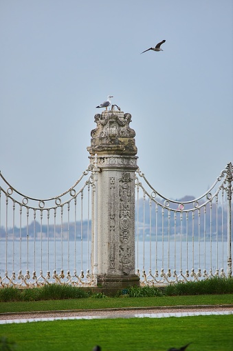 Istanbul, Turkey - November 23, 2021: The famous Dolmabahce Palace. The column of the fence separating from the Bosphorus Strait.