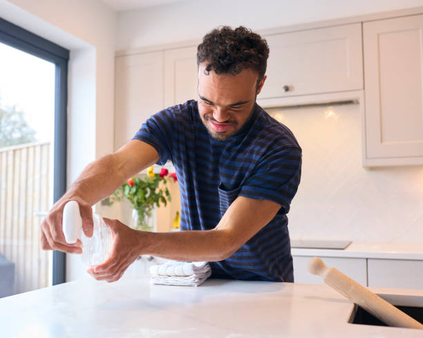 istock Man With Down Syndrome Cleaning And Clearing Up After Meal In Kitchen 1707786675