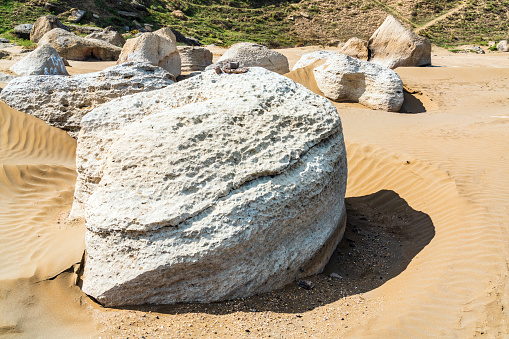 Huge boulder on the sand