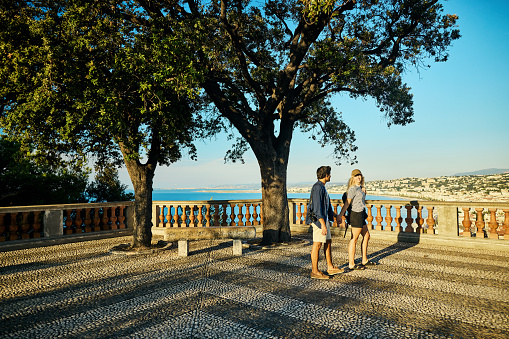Adult couple holding hands while exploring Castle Hill, above Nice, France on the French Riviera.