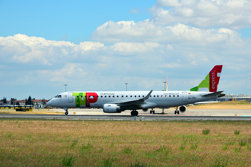 Lisbon, Portugal: a TAP Express Embraer E190LR (registration CS-TPU - MSN 506, named Setúbal) taxiing at Lisbon International Airport - portside view. TAP Air Portugal is the flag carrier of Portugal, headquartered at Lisbon Airport which also serves as its hub. TAP Express / Portugalia is TAP Air Portugal's regional airline, operating short and medium-haul flights.