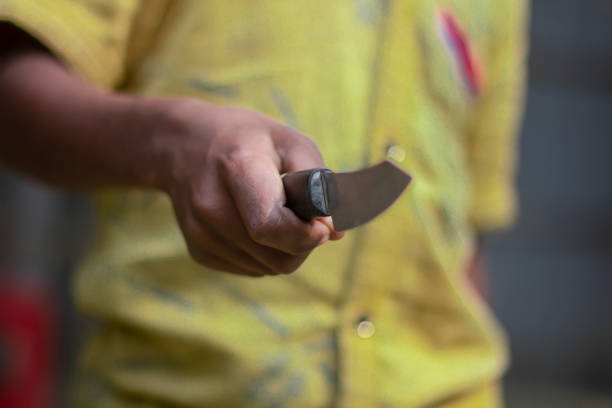 istock A boy is holding a knife in his right hand 1707845973