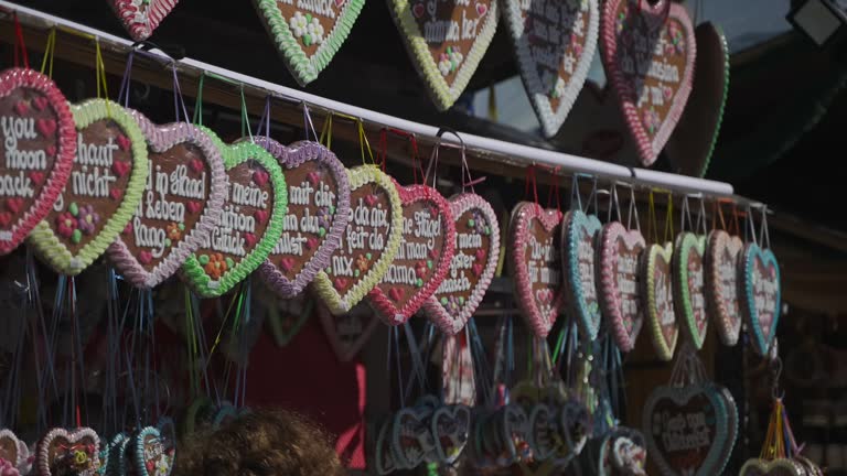 Typical souvenir at Beer Fest in munich. Gingerbread heart. Lebkuchenherz. Stall selling gingerbread at market for Bavaria yearly Beer Fest festival. Verkauf von Lebkuchen auf den Wiesen.