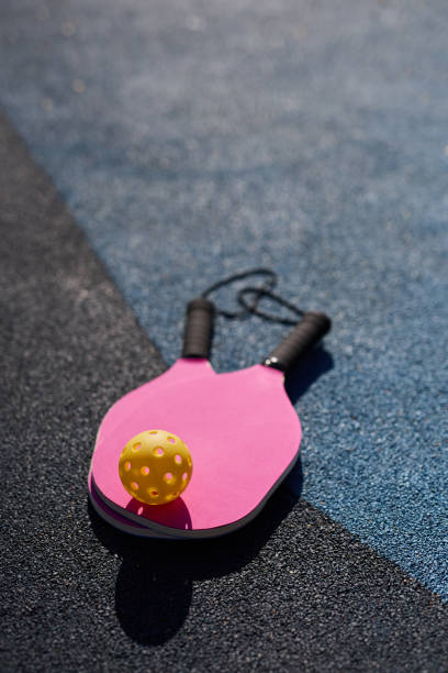 istock Pickleball rackets and a ball lying on court 1707853673