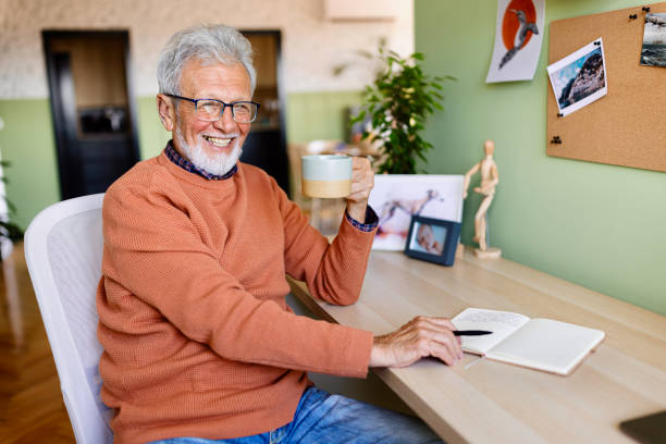 istock Smiling senior man writing memoirs 1707898027