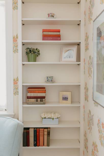 istock Minimalist white wall-mounted bookshelf, featuring clean lines and contemporary design. 1707898573