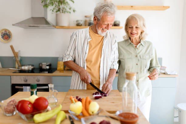istock Joyful senior couple preparing food 1707899661