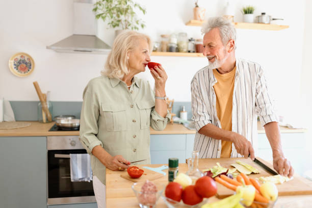 istock Lovely senior couple preparing lunch in the kitchen 1707900763