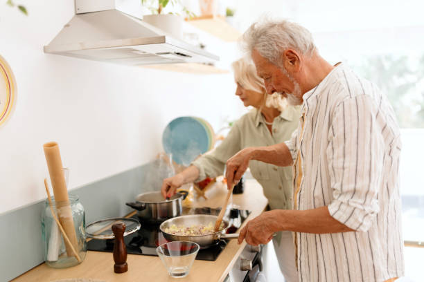 istock Senior people preparing lunch in the kitchen 1707904122