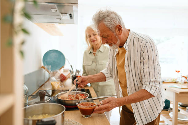 istock Loving senior couple preparing lunch in the kitchen 1707906973