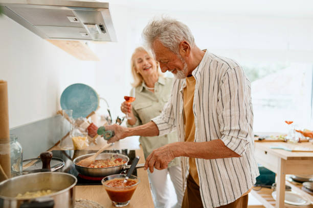 istock Relaxed senior couple enjoying while preparing lunch 1707907470